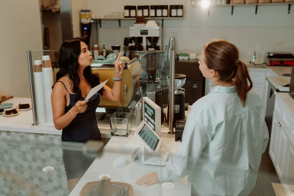 Barista taking an order from a customer at a café counter